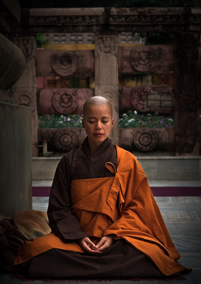 Tibetan nun meditating and breathing
